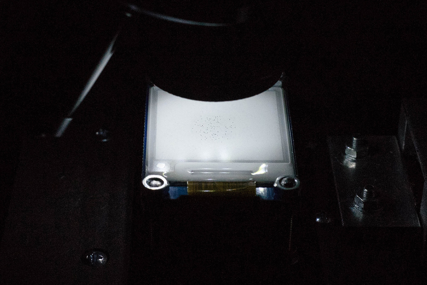 closeup on microscope stage mit mounted e-ink screen with tiny black dots