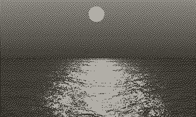 a illuminated microscope on a table with a chair in a dark exhibition space