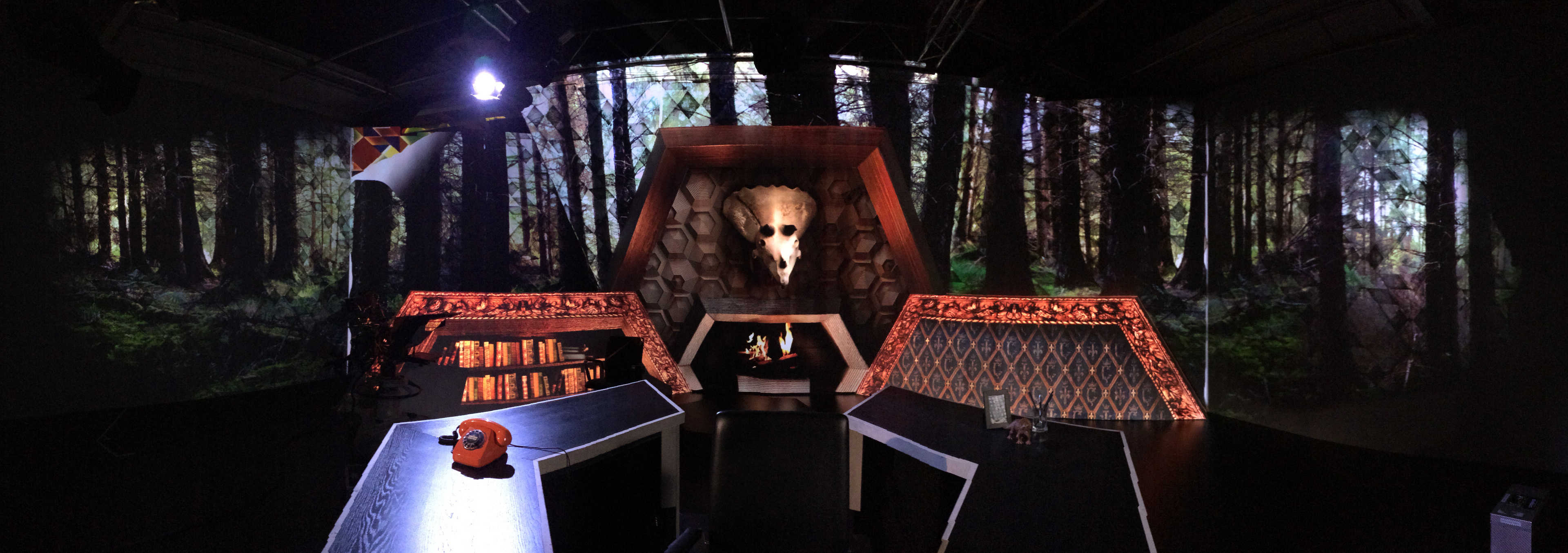 TV studio panorama with hexagonal desk in the front and projection mapping background